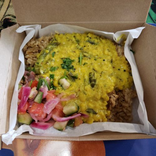 Golden red lentil dahl served with rice and salad