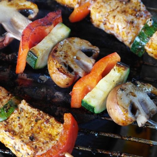 Tofu, mushroom and vegetable skewers on a barbecue grill