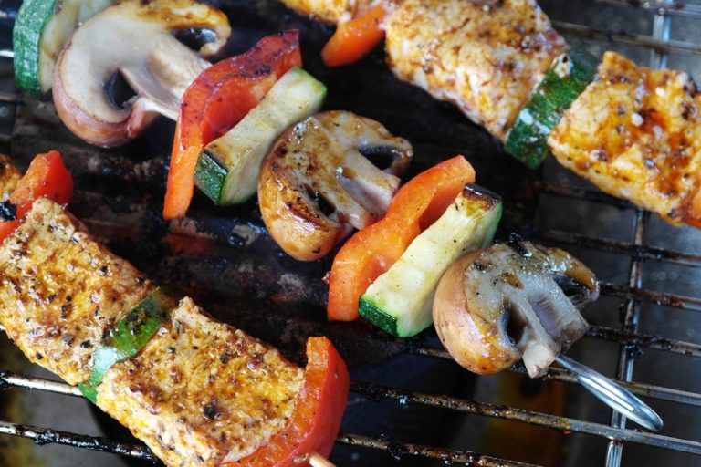 Tofu, mushroom and vegetable skewers on a barbecue grill